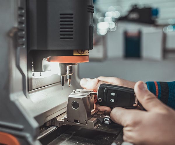 locksmith cutting a replacement automotive flip key locksmith cutting a replacement automotive flip key