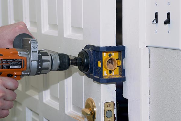 Drilling a door for a new deadbolt installation